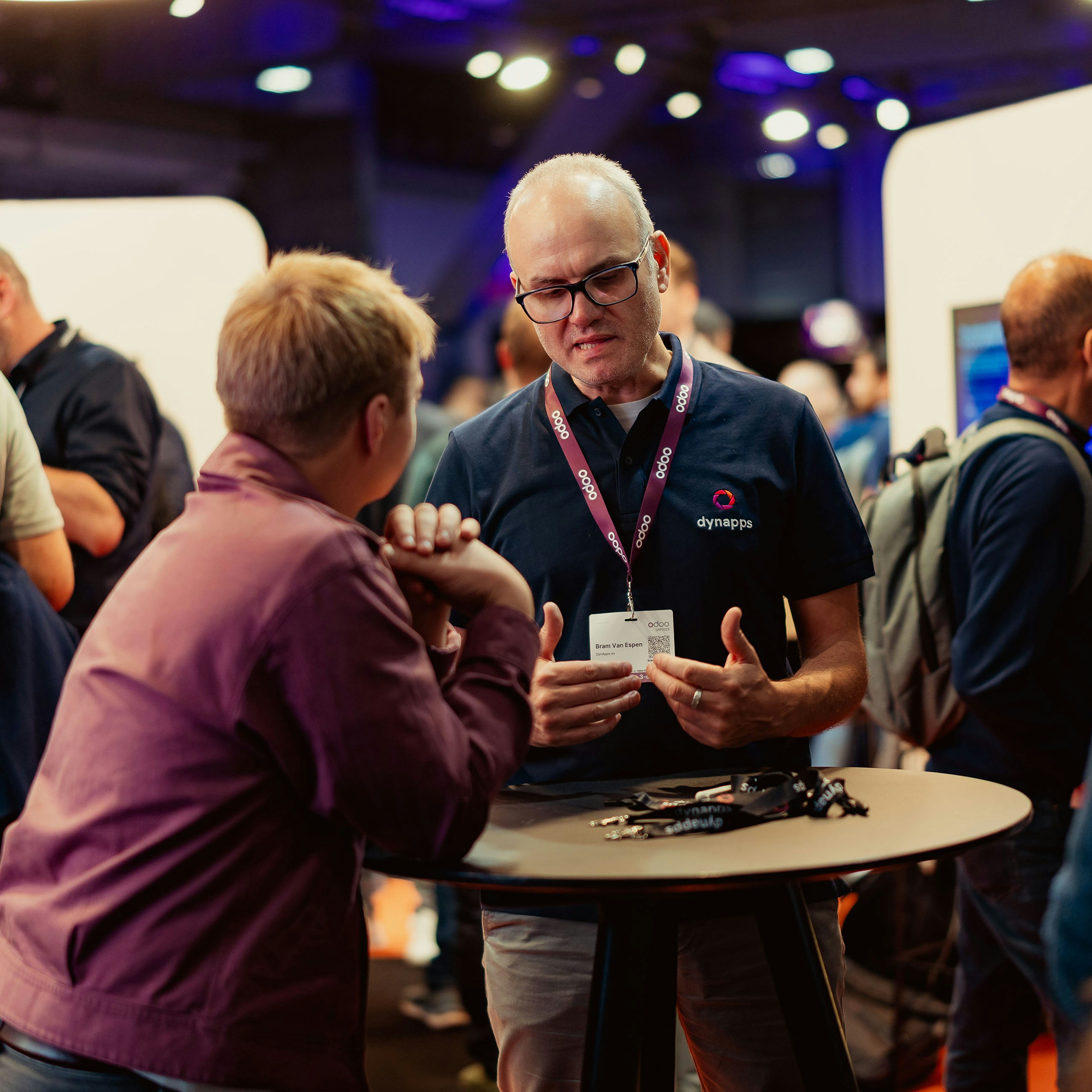 Dynapps consultant in conversation at a crowded event stand