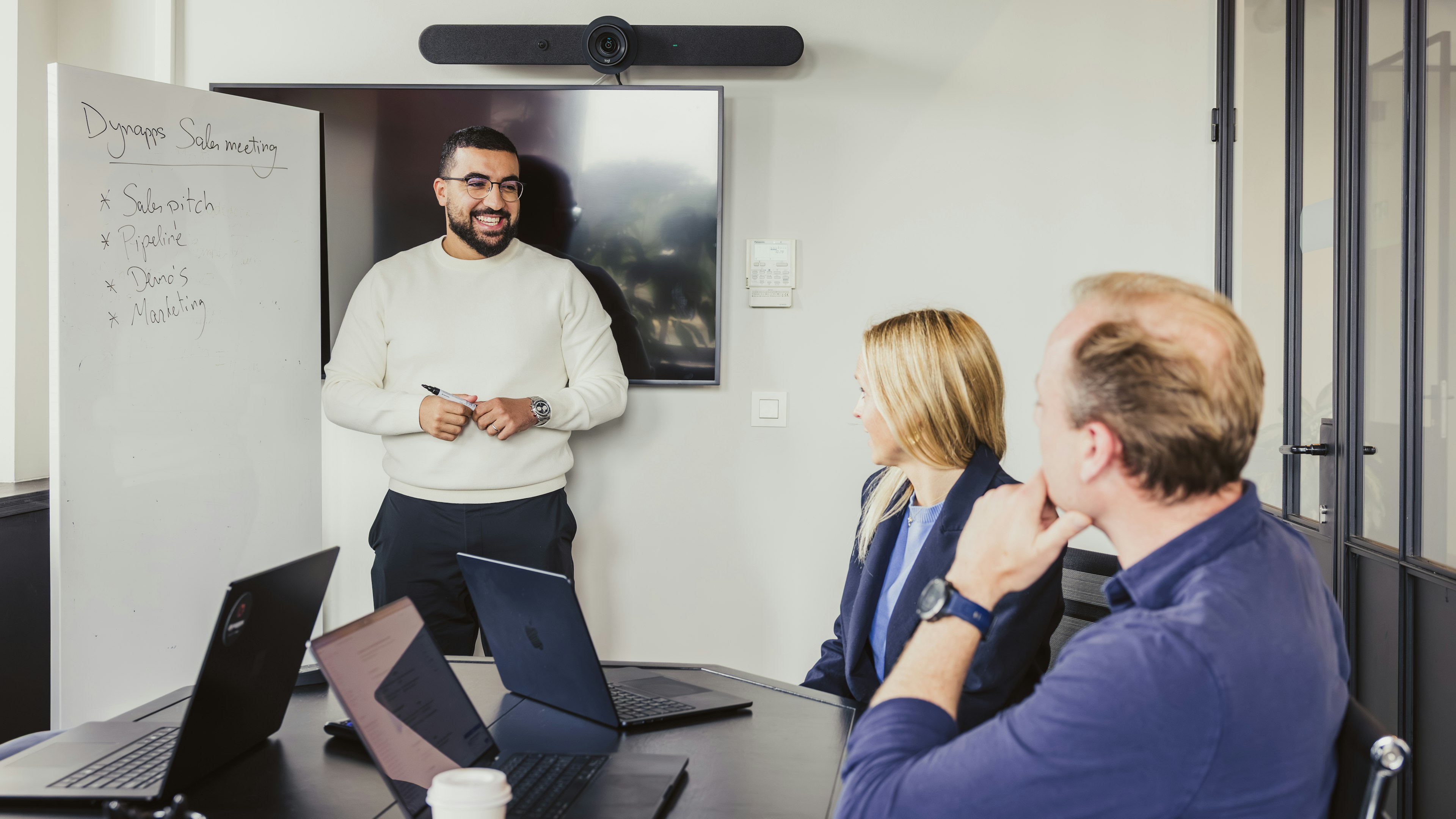 Presenter at whiteboard during a Dynapps sales meeting