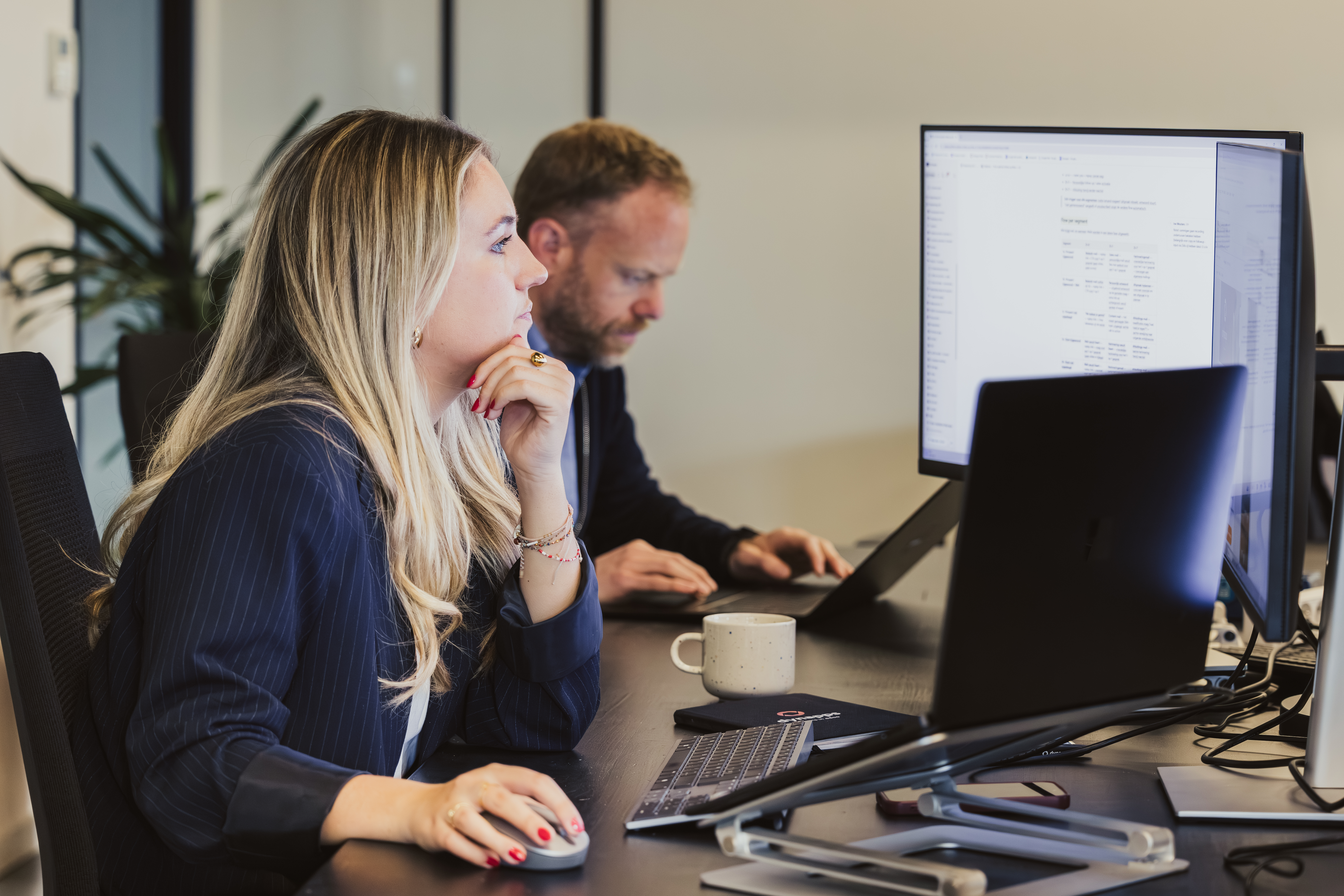 Colleagues concentrating at dual-screen workstations