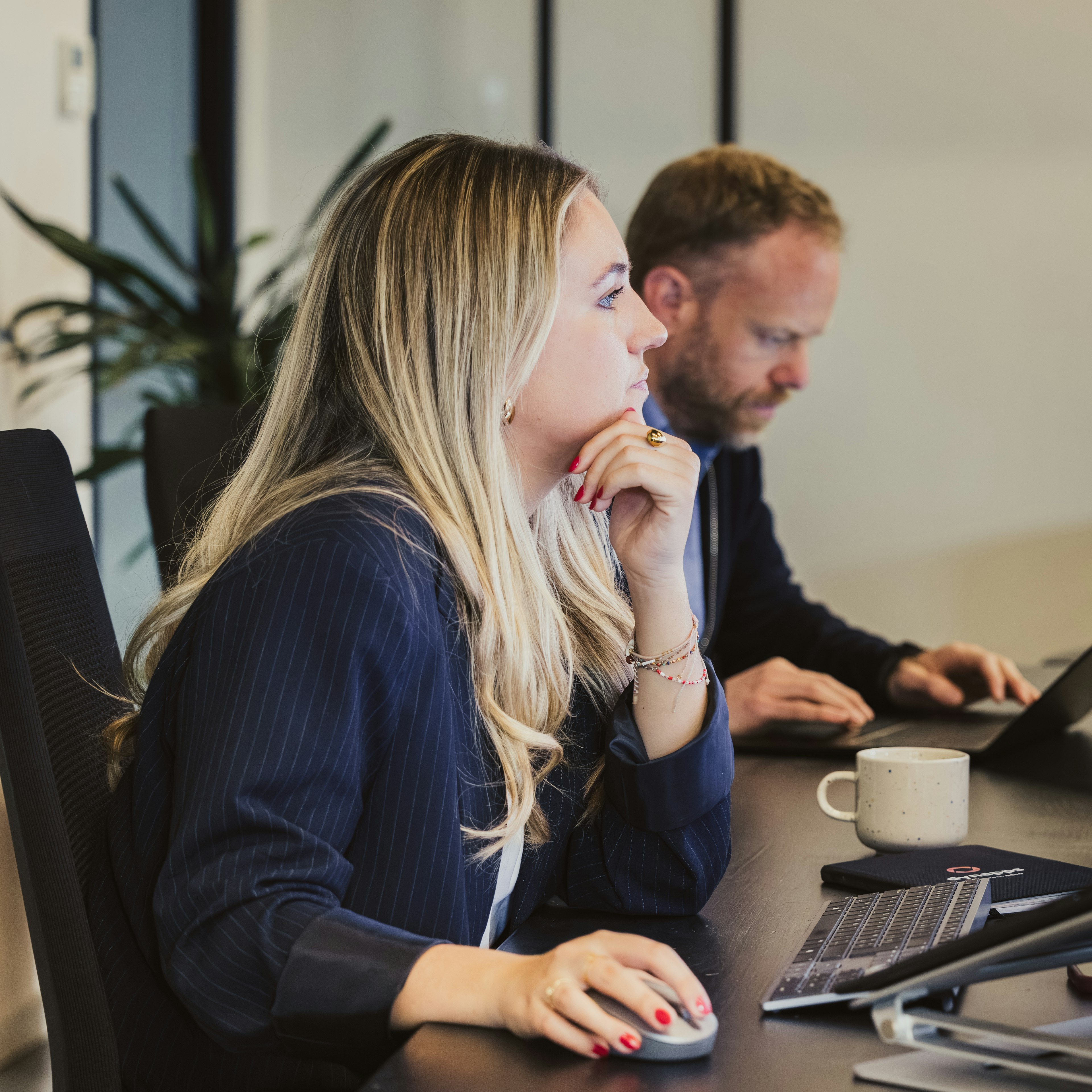 Colleagues concentrating at dual-screen workstations
