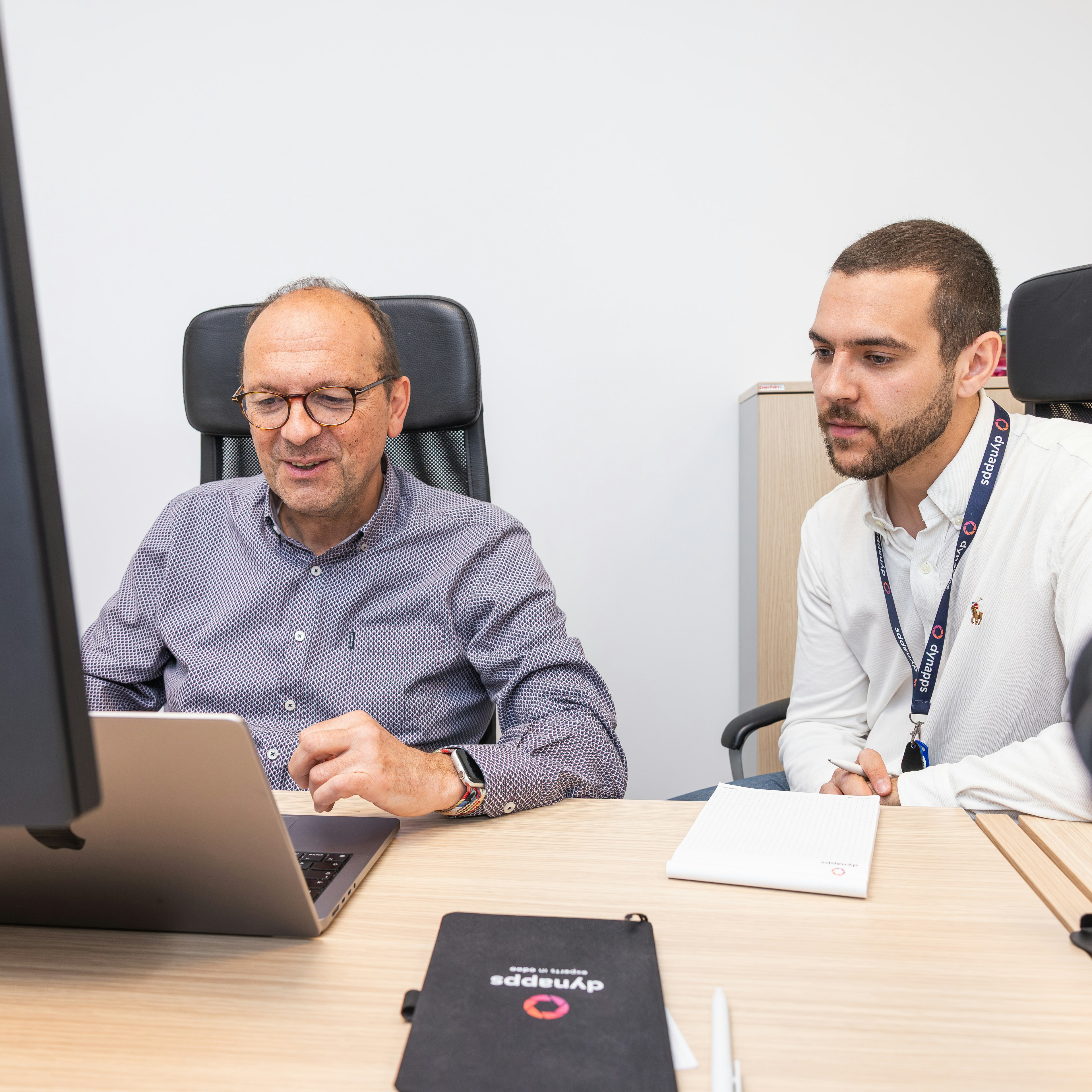 Two Dynapps colleagues reviewing work on a tablet