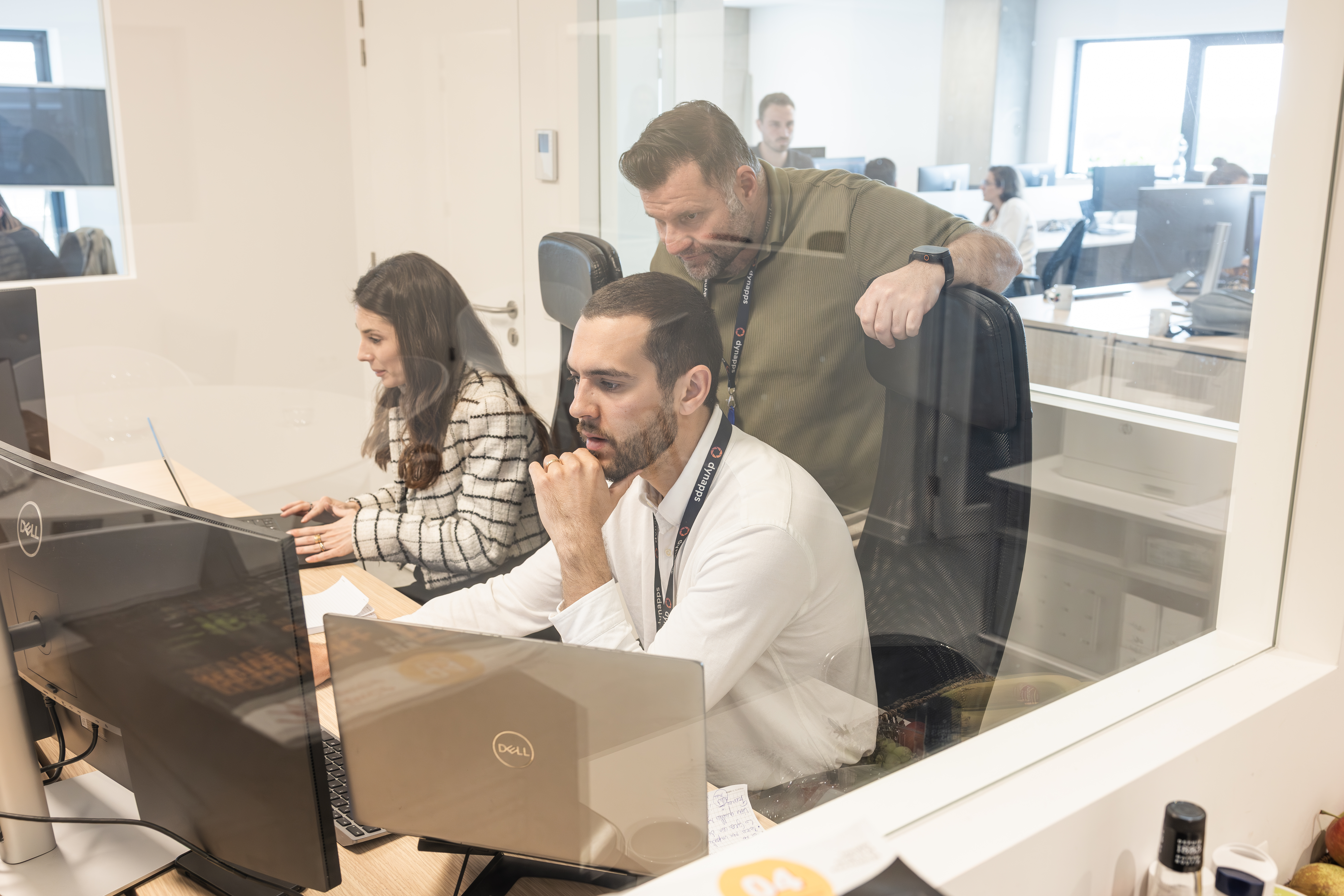 Dynapps consultants reviewing a screen together in the office