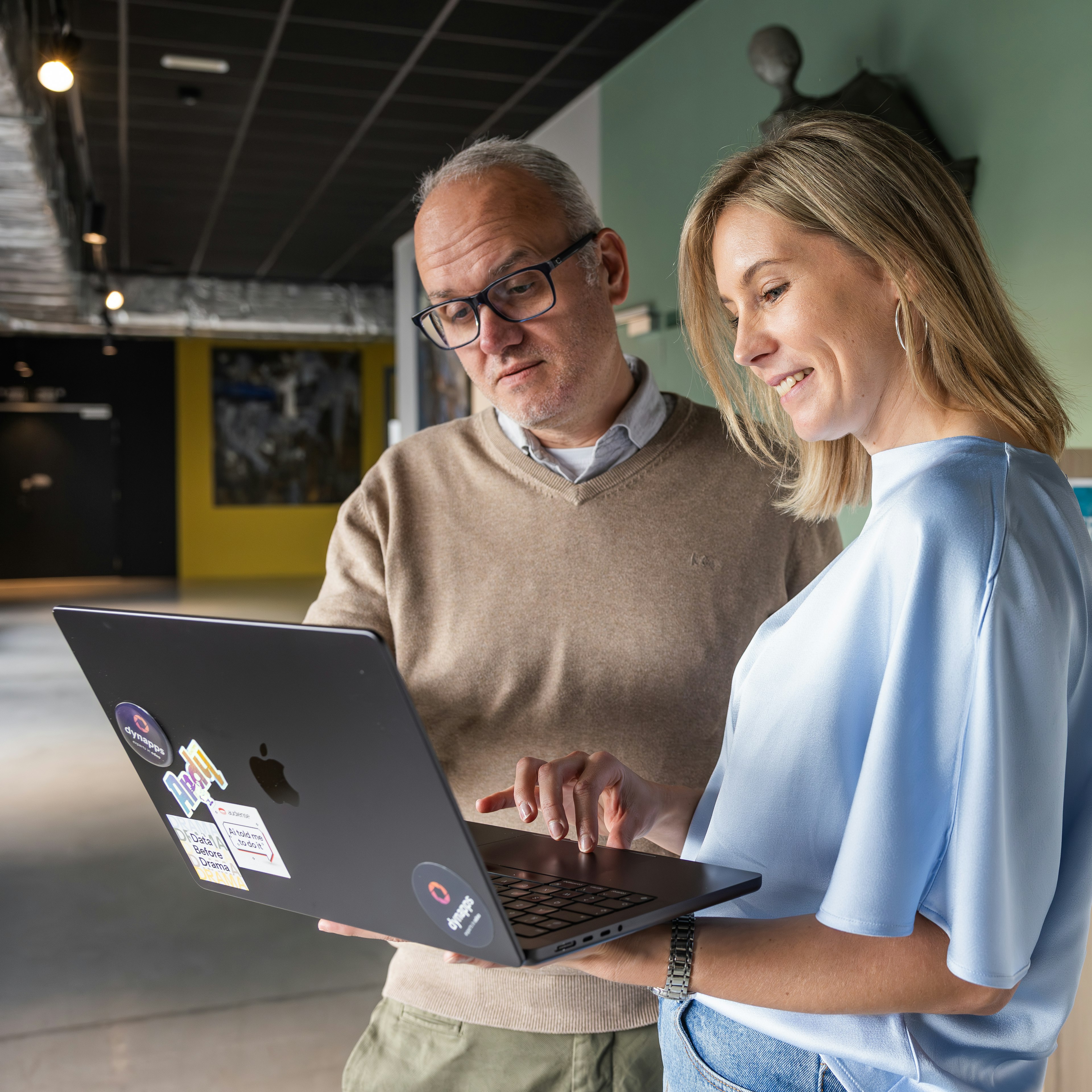 Two Dynapps colleagues reviewing work on a laptop