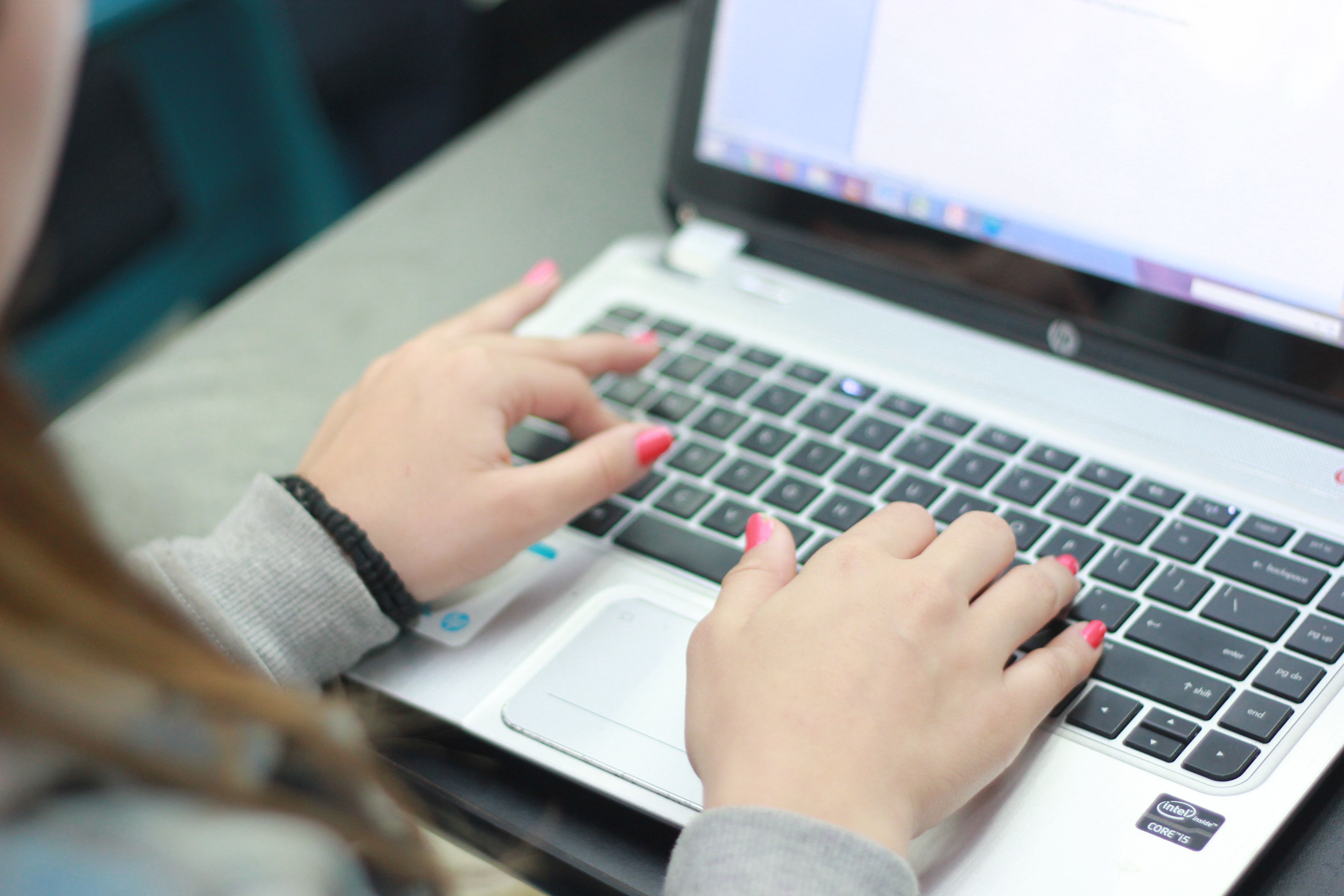 A girl typing on a computer