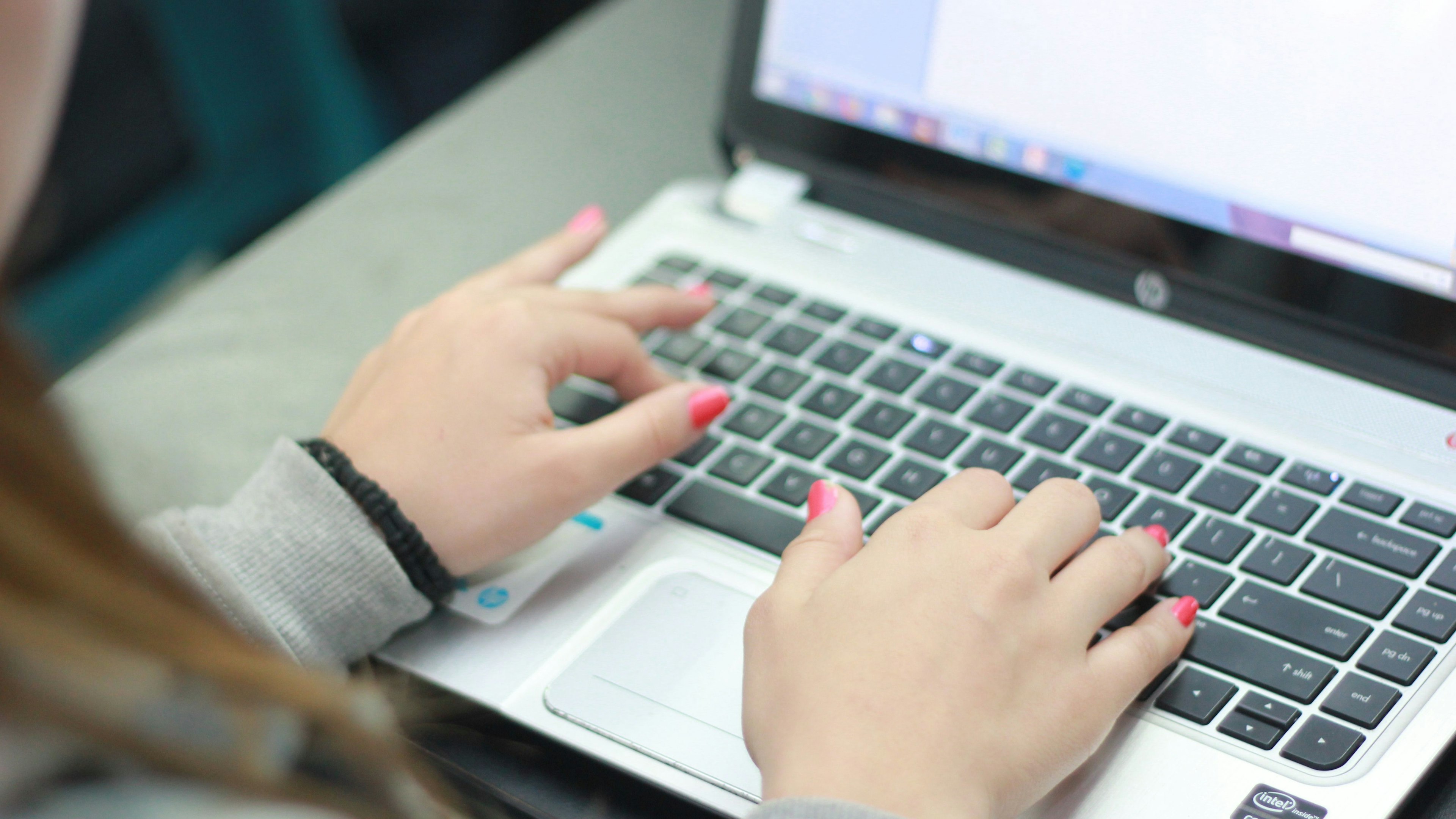 A girl typing on a computer