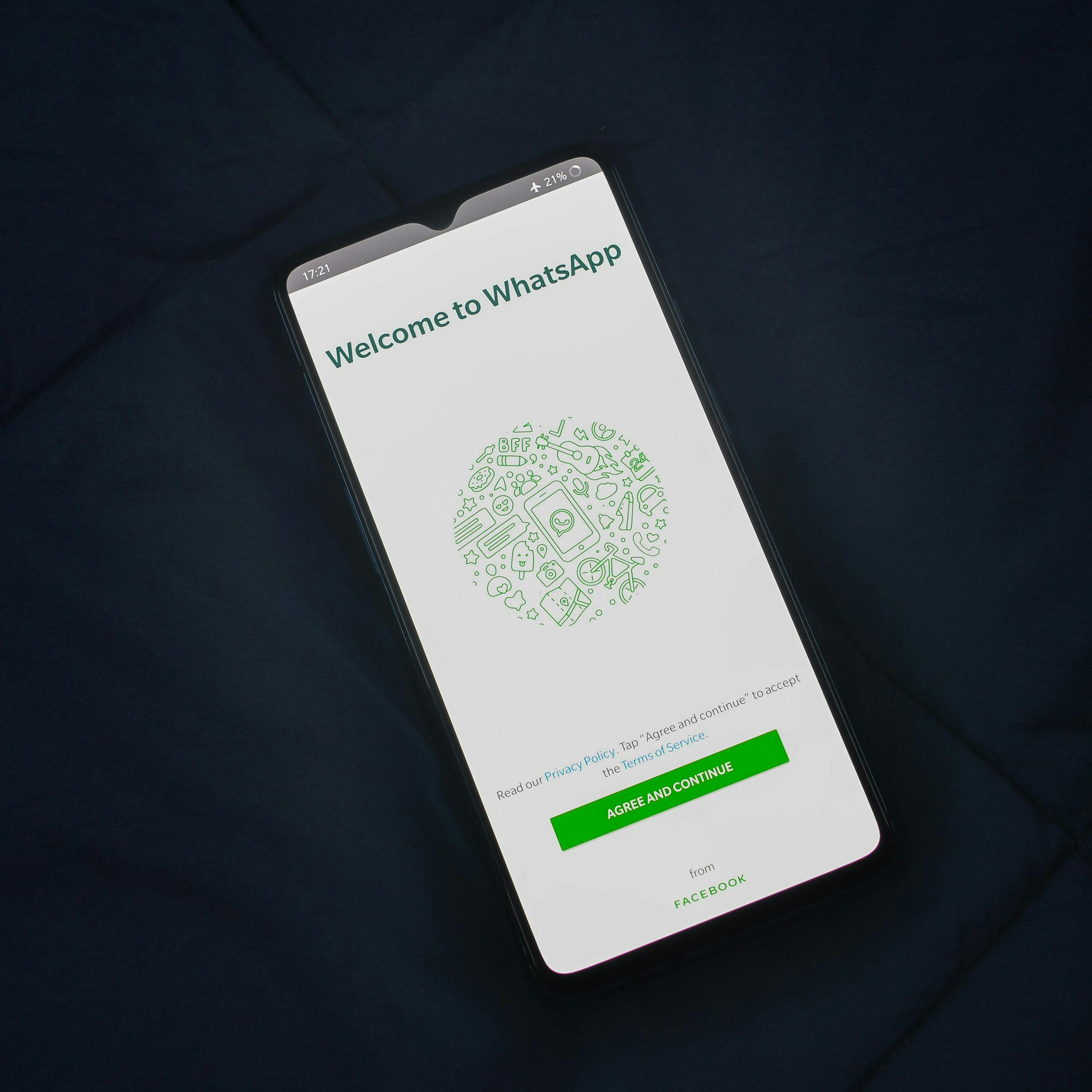 A cell phone with WhatsApp on the home screen