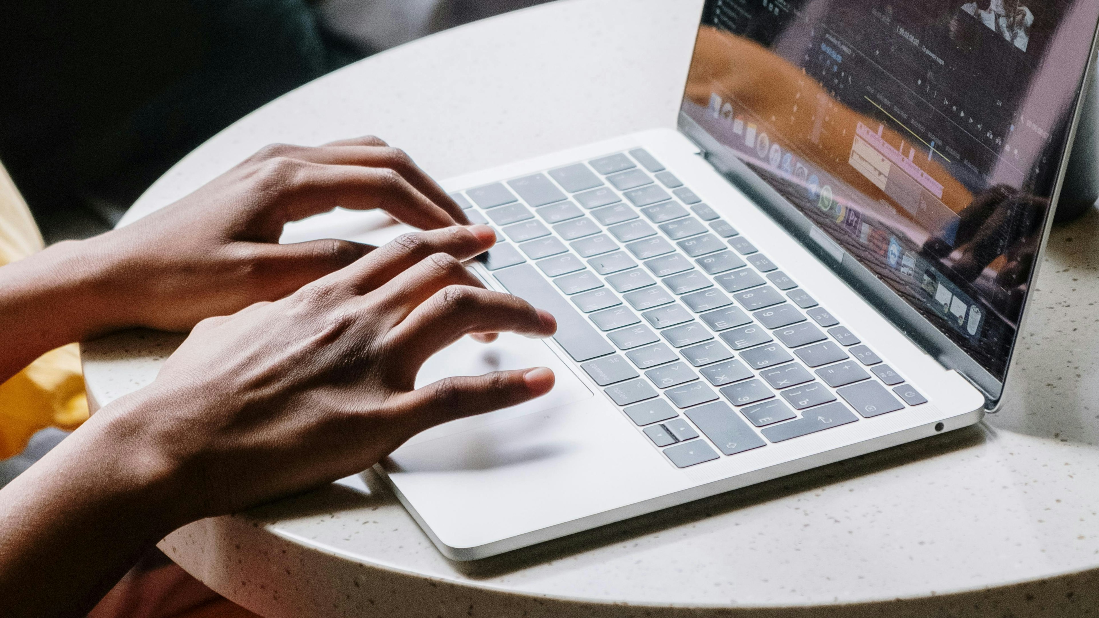 A person typing on a computer, on WhatsApp