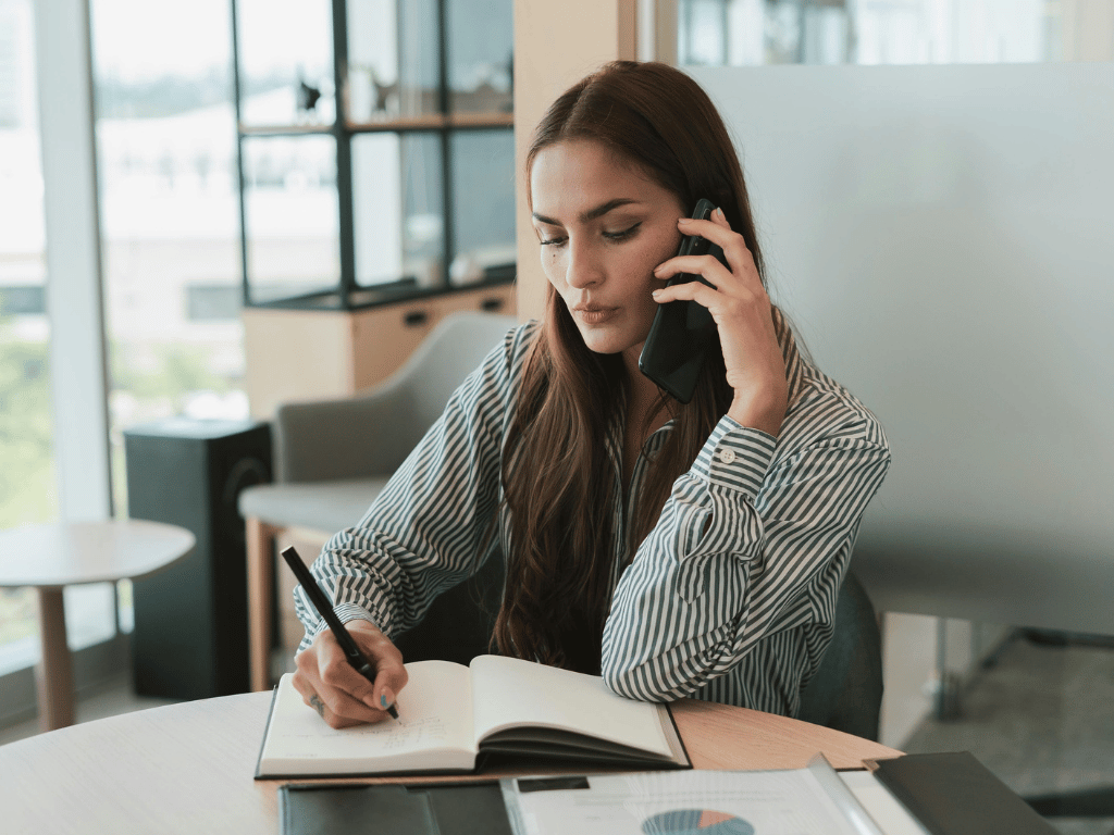 Woman in an office, taking a call