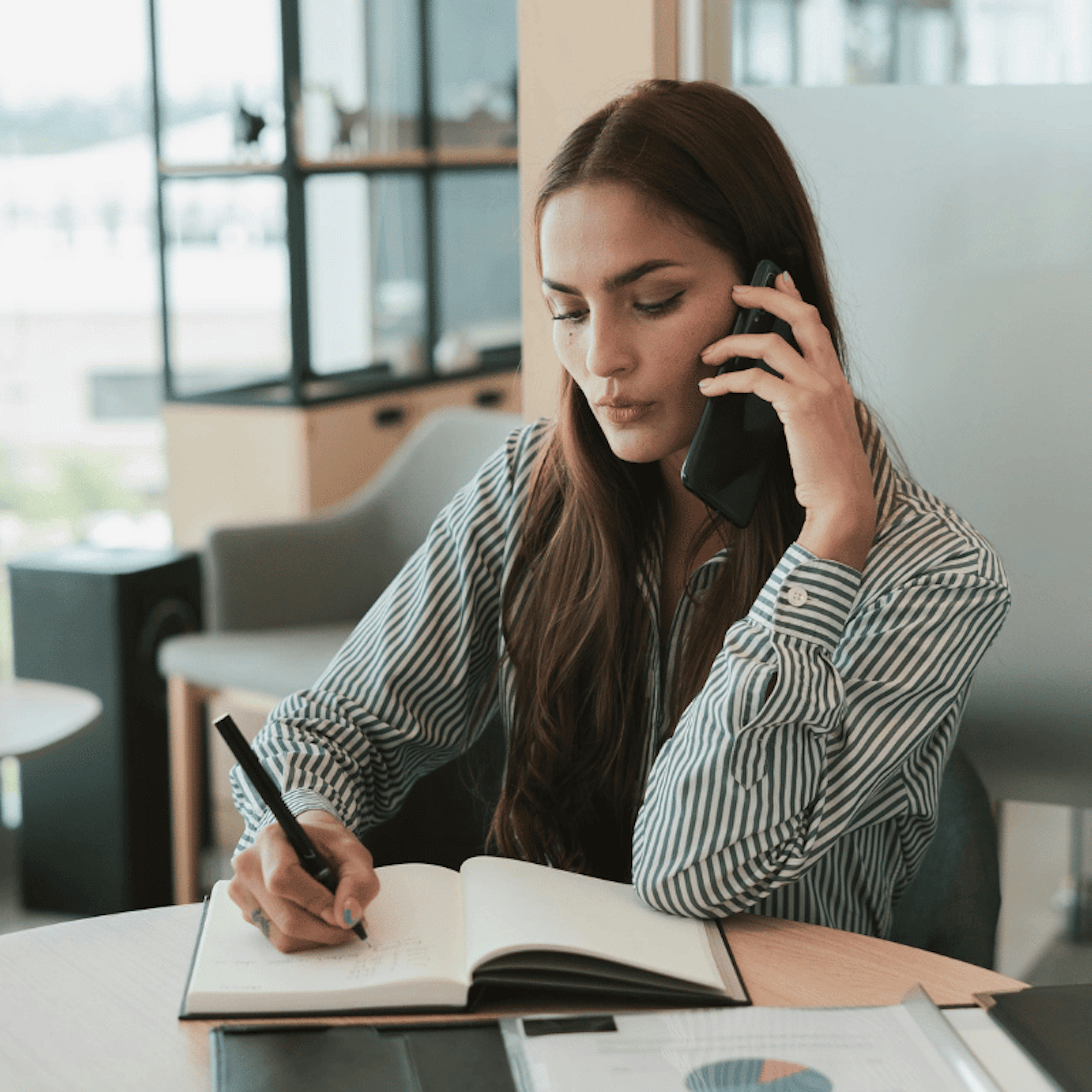 Woman in an office, taking a call