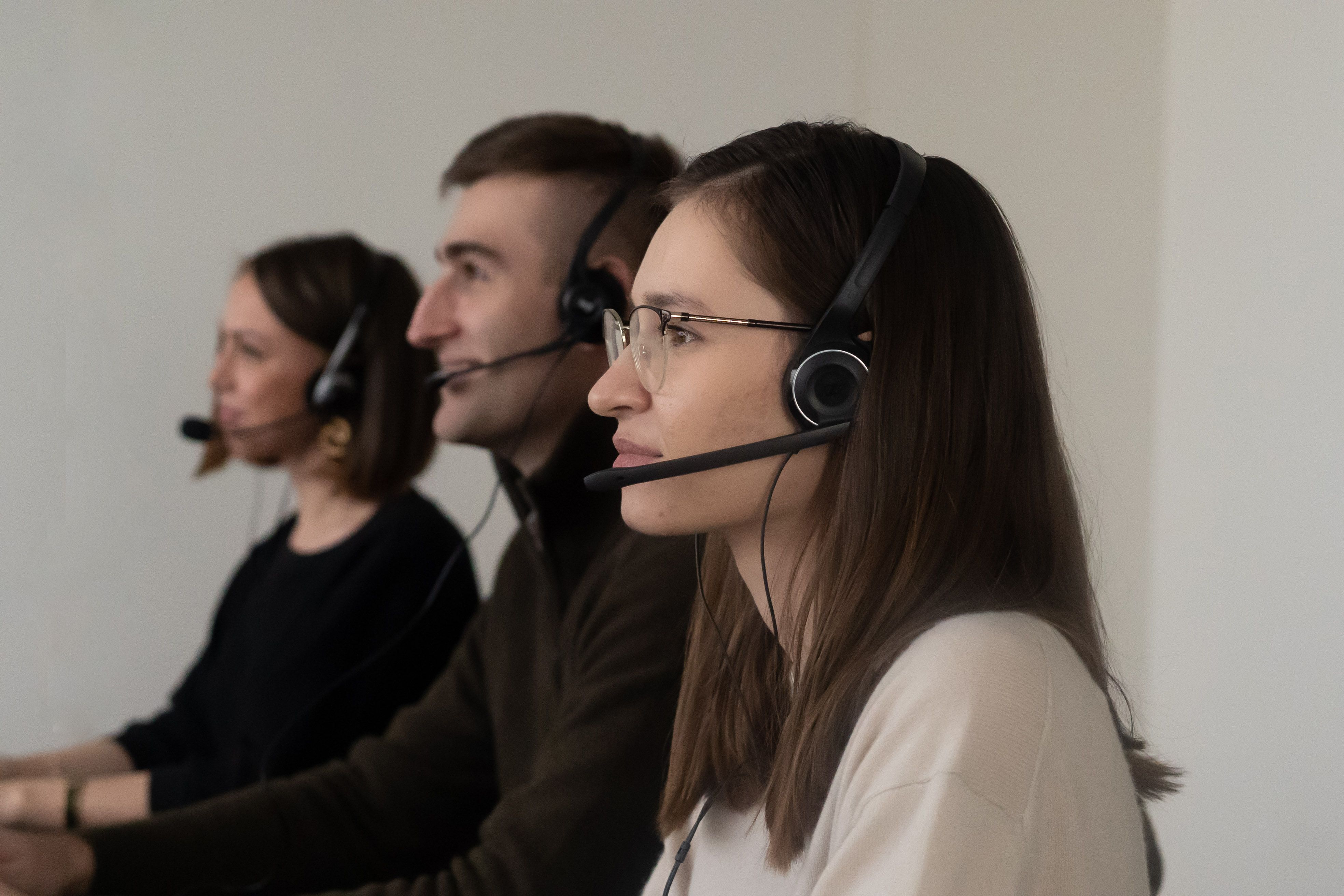 Customer service team with headsets at their desks