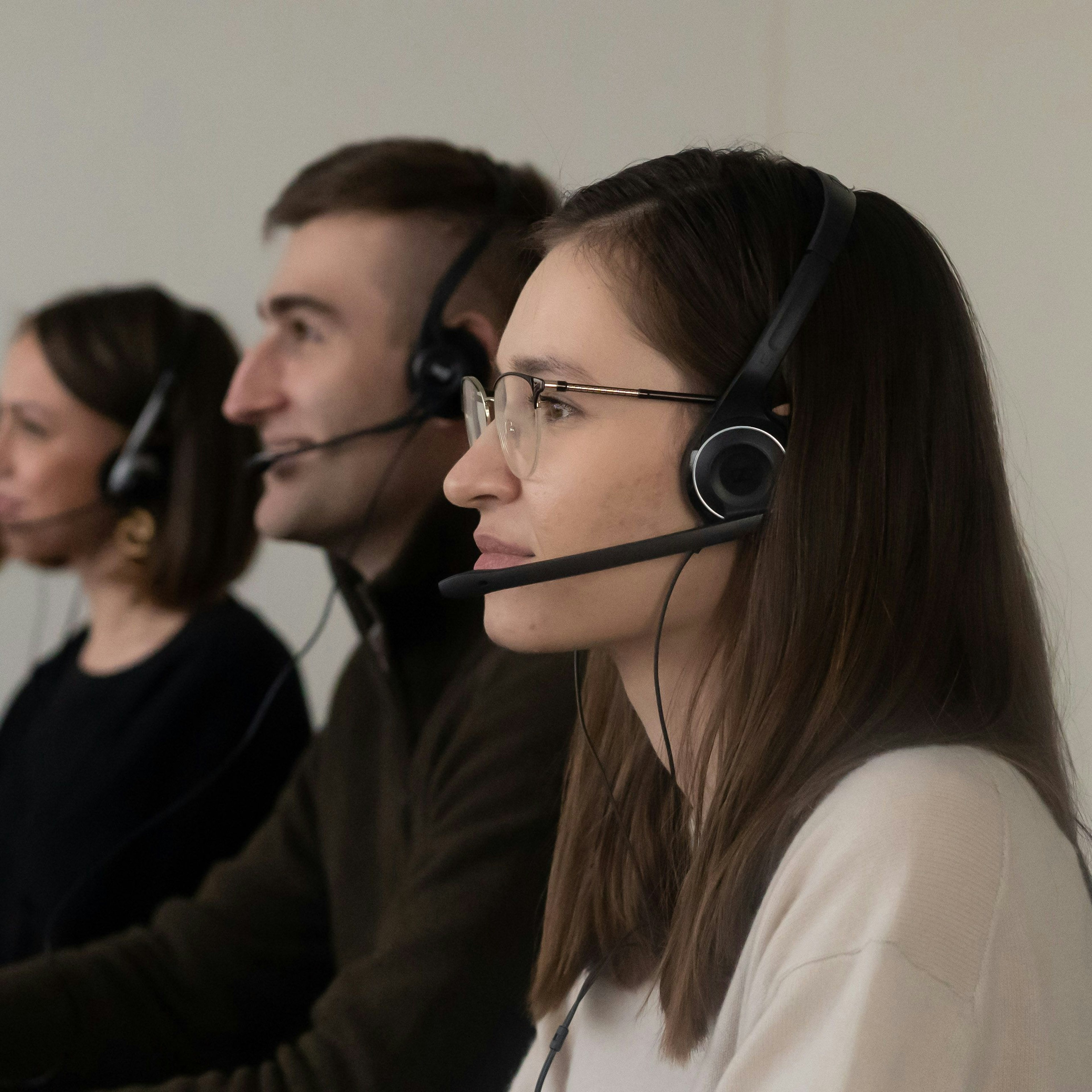Customer service team with headsets at their desks