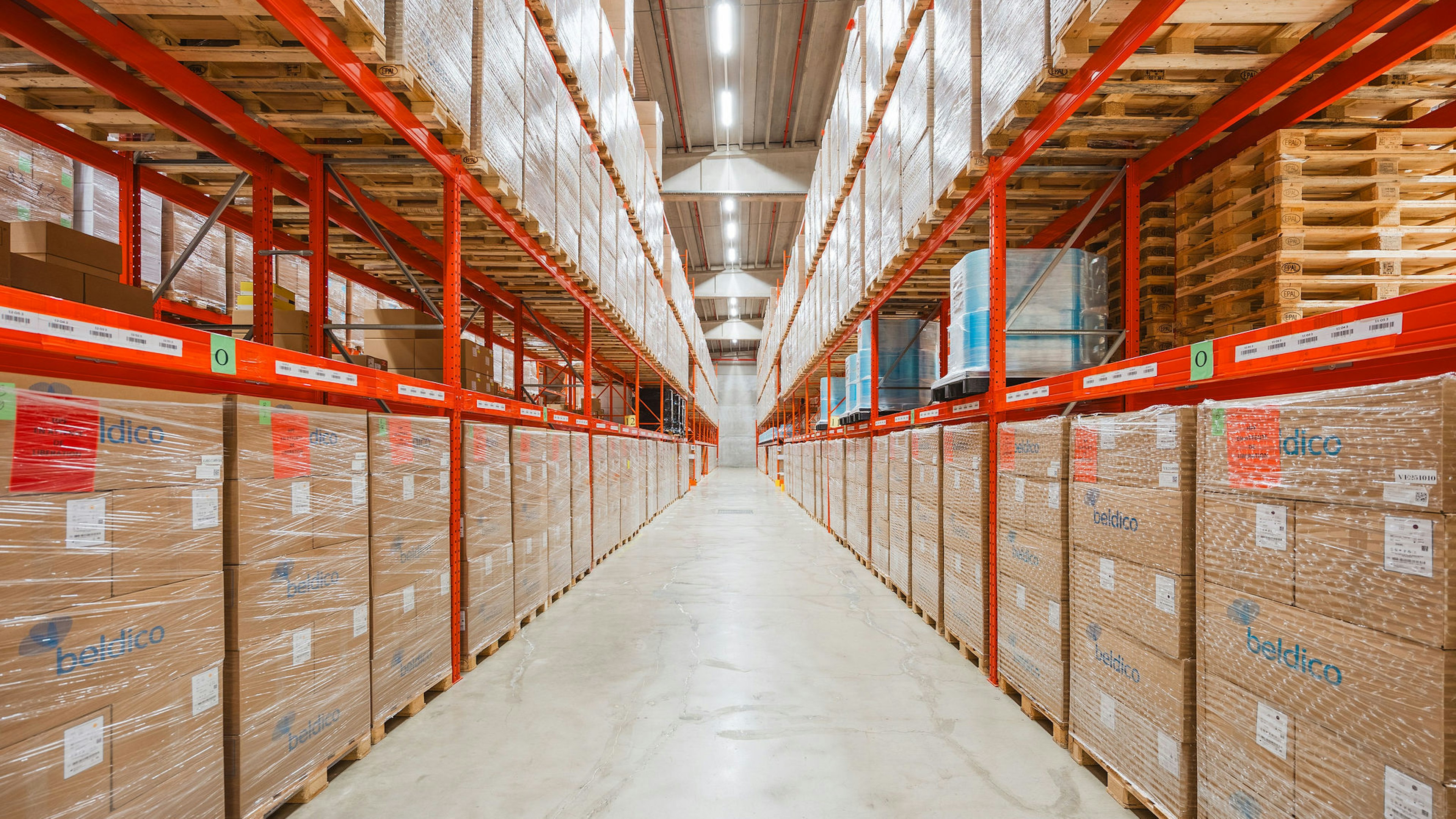 Warehouse aisle with pallet racking full of Beldico boxes