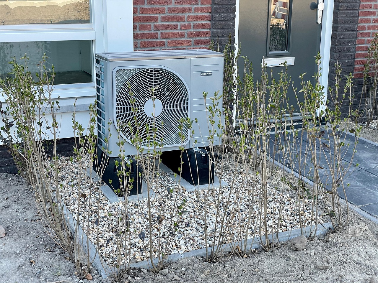 Outdoor heat pump unit installed in front of a house