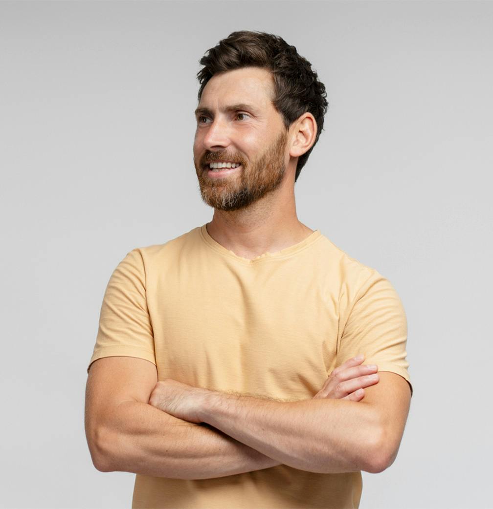 man crossing arms looking to the side