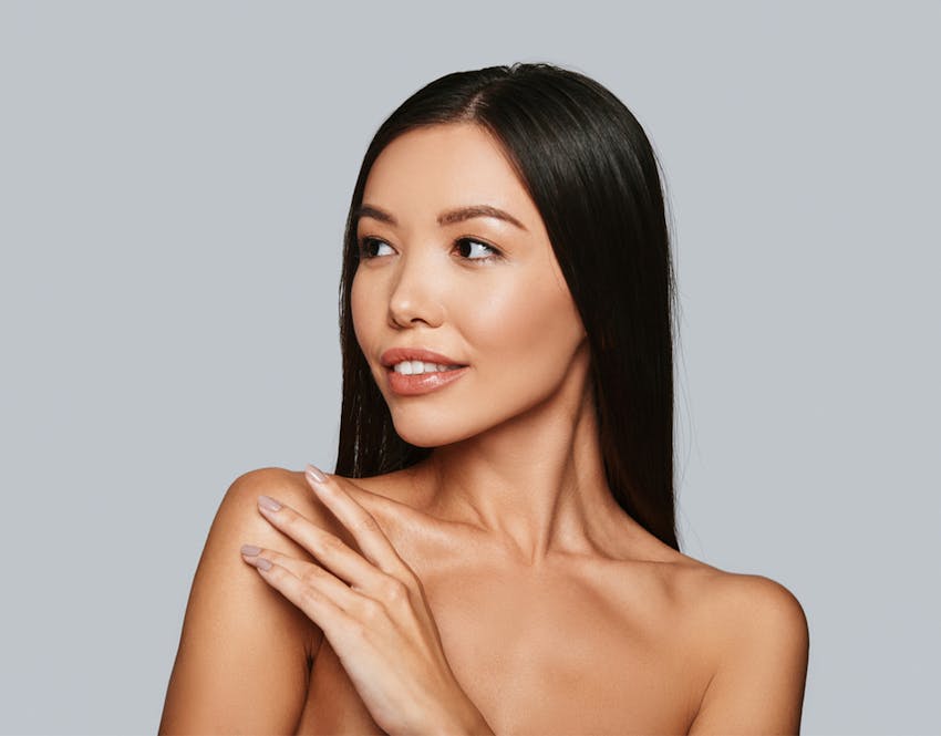 woman touching shoulder looking to the side