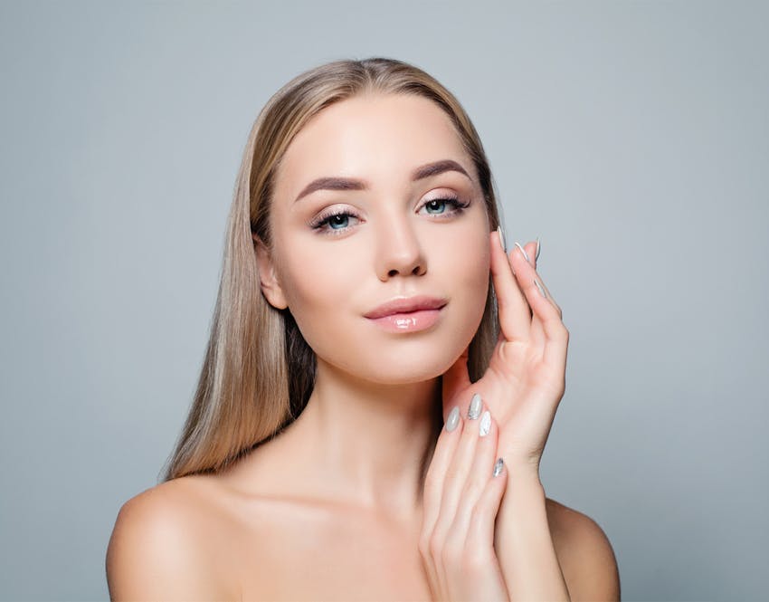 woman touching her face