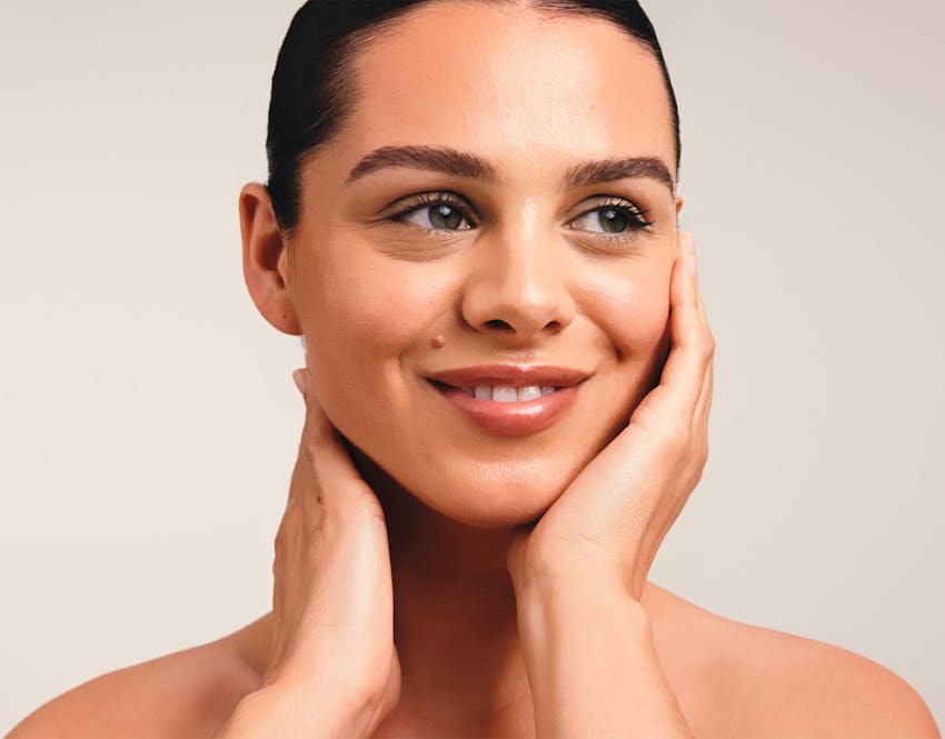 woman holding face in hands