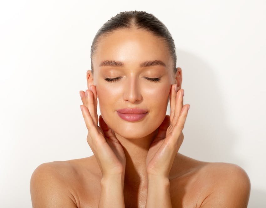 woman holding face in hands
