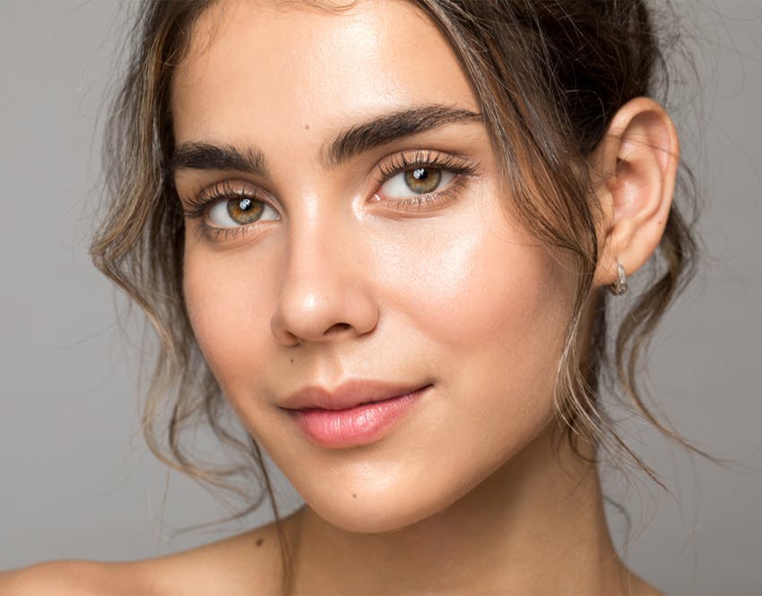 close up of womans face with a soft smile