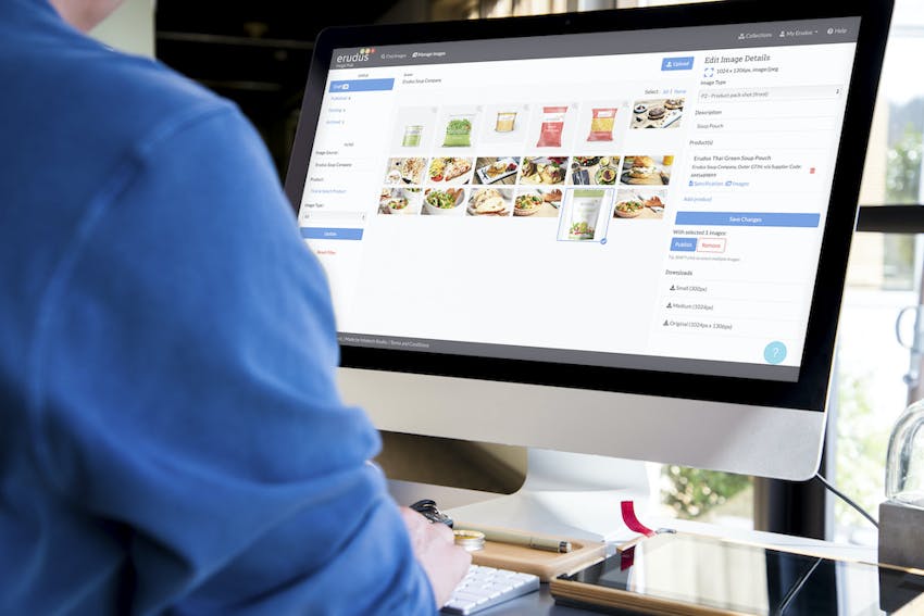 Man looking at Erudus Image Hub images on desktop computer 