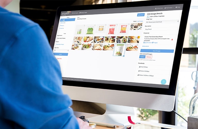 Man looking at Erudus Image Hub images on desktop computer 