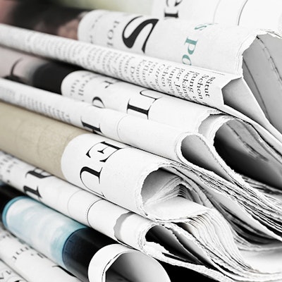 Erudus Newsroom Newspapers Piled Neatly