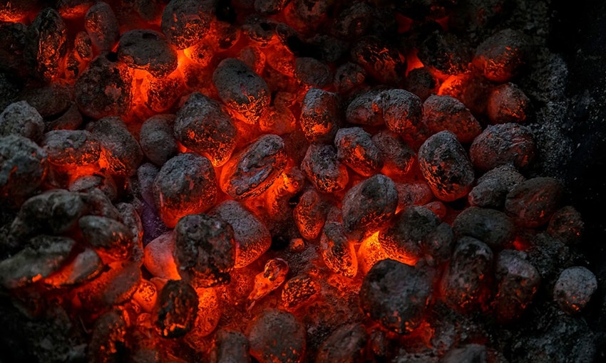 Nearly all experts agree that a charcoal grill is the best. fiery red and black burning charcoal