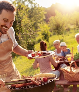 Family enjoying a BBQ Image of a family enjoying a BBQ