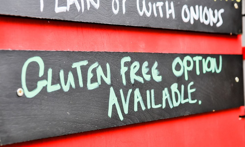 Menu board with  wooden gluten free options available sign 