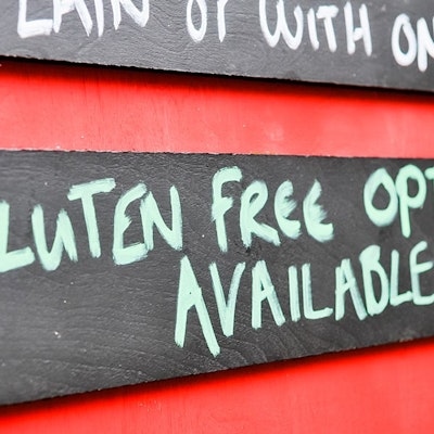 Menu board with  wooden gluten free options available sign 