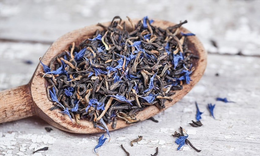 Wooden spoon full of earl grey tea leaves 