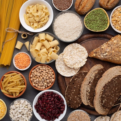 Fresh Sliced Bread Loaf of Crusty Sliced Bread on wooden chopping board placed on dark wood table