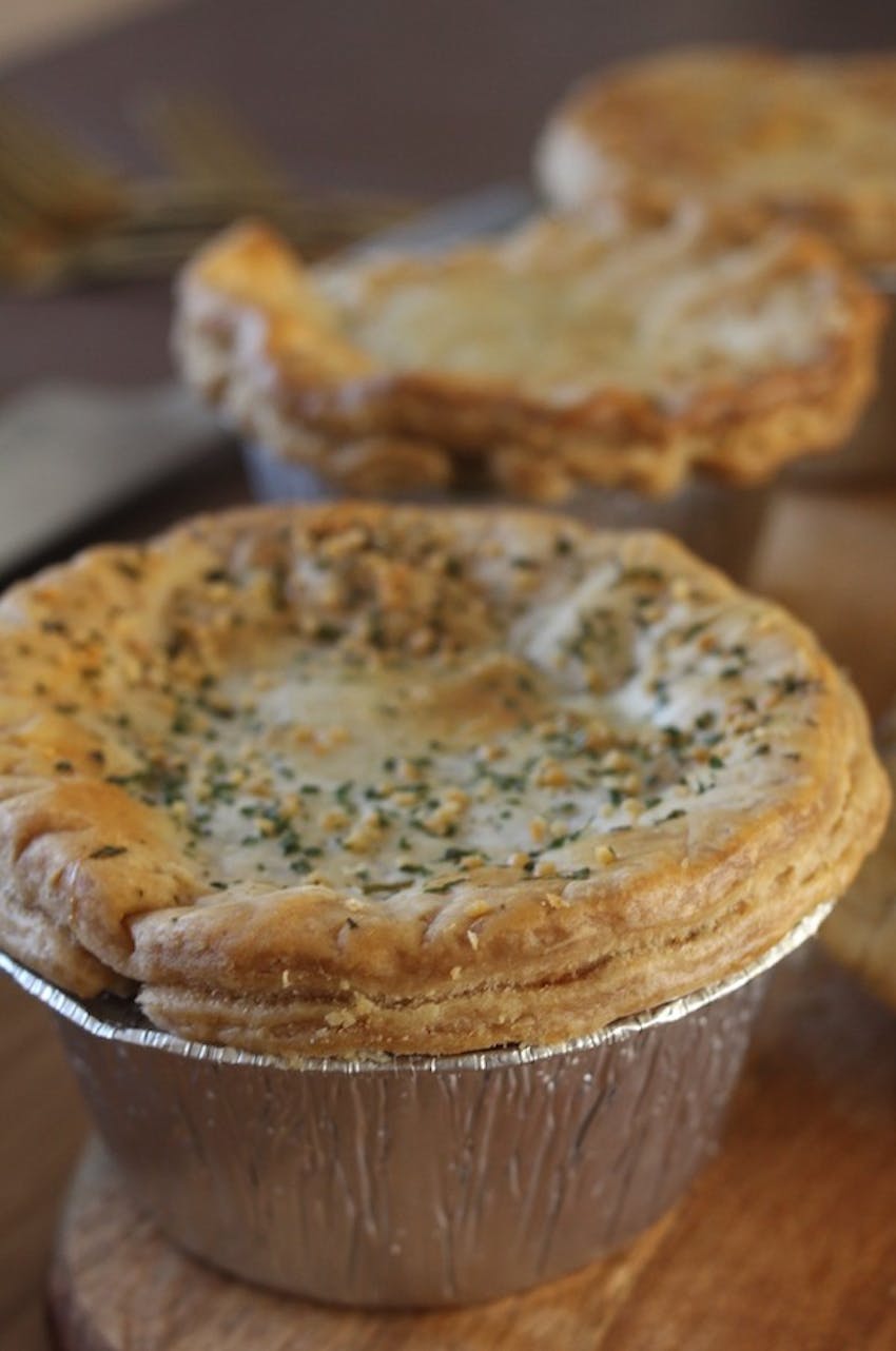 fields and forest foods vegetarian vegan pie in foil case topped with herbs 
