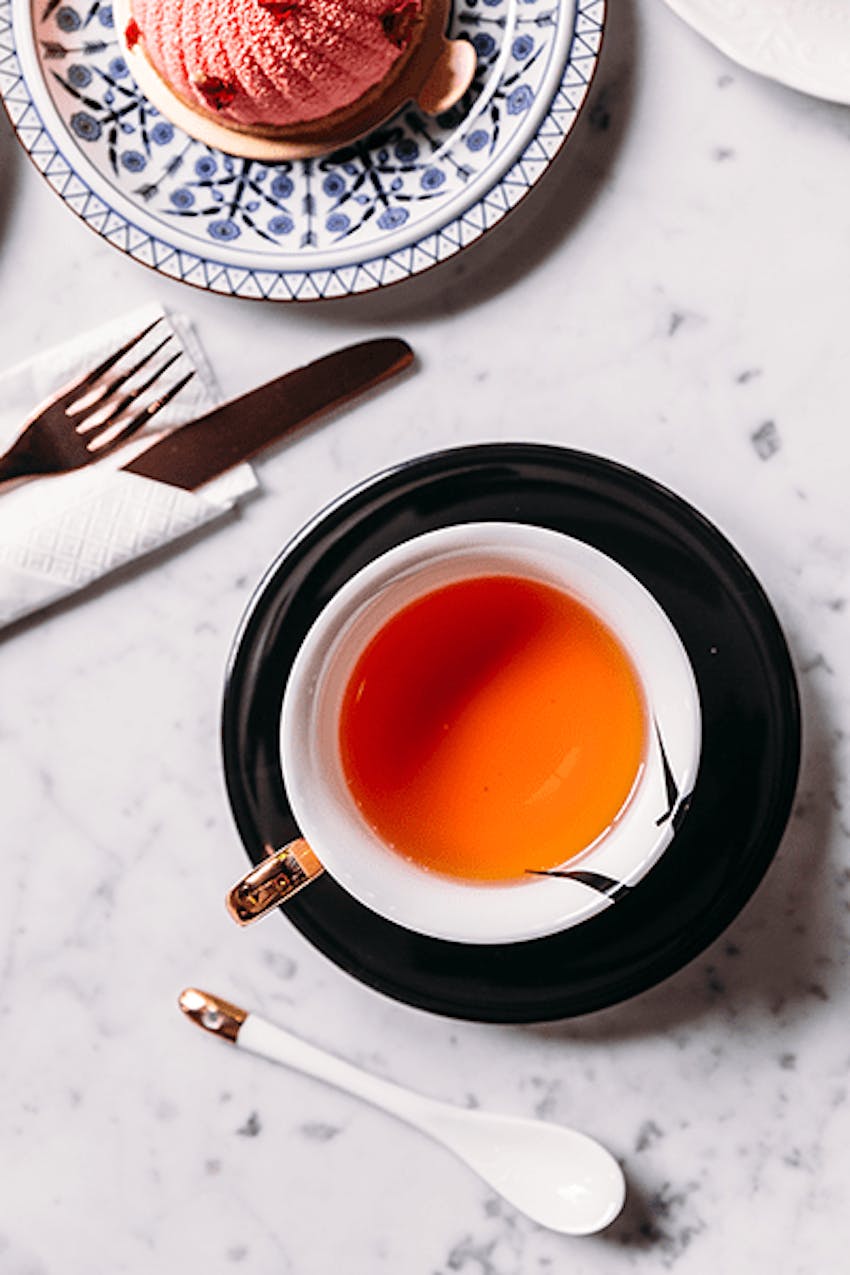 Mug of herbal tea in saucer 