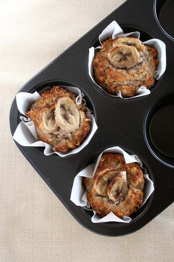 three crispy banana breakfast muffins in a baking tray 