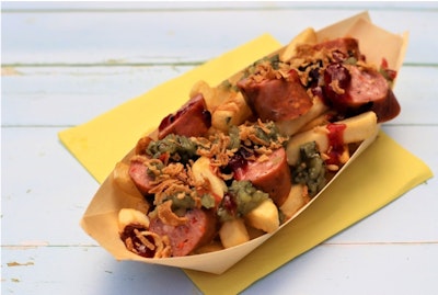 fries topped with wild boar frankfurter, crispy onions, bostongurkha, and lingonberry jam in a cardboard try 