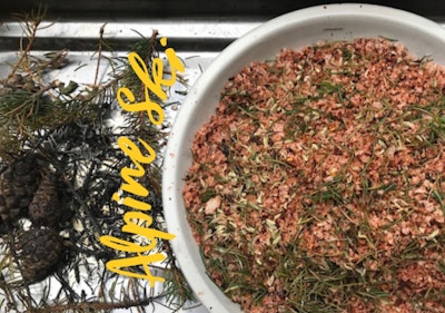 a bowl of smoky spice mix with fresh herbs and pine needles 