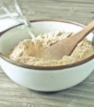 Dry ingredients being mixed together in a large white bowl 