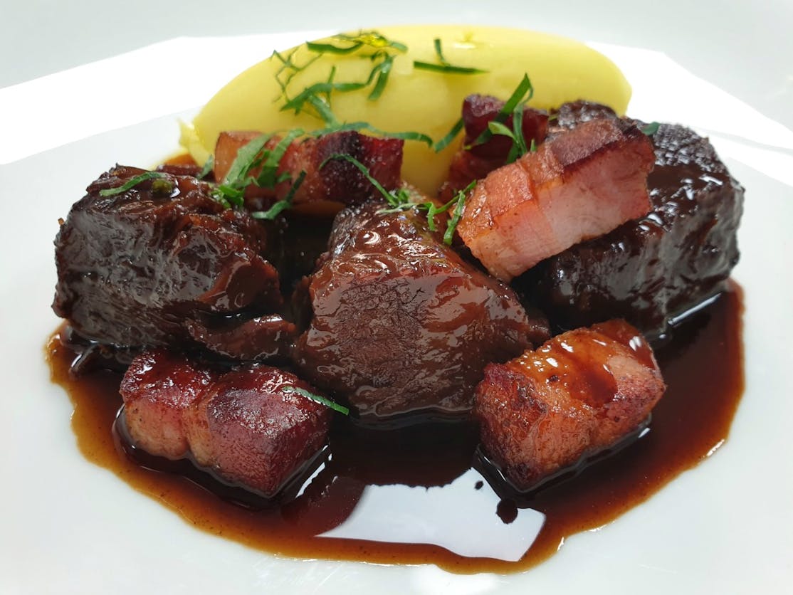 Braised Beef in Red Wine and Port Braised Beef in a Red Wine and Port jus with creamy mash potato topped with fresh herbs