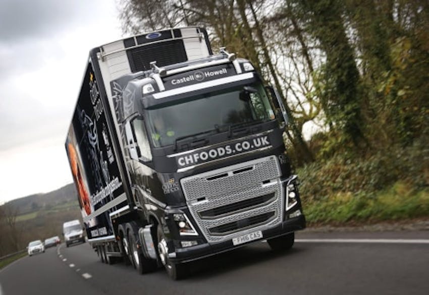black and silver castell howell lorry driving through the countryside 