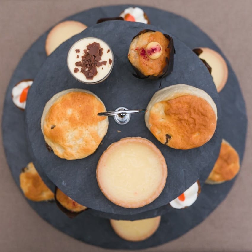 birds eye view of terrys patisserie afternoon tea box with tiered cake tray with various baked goods 