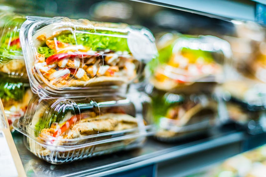 freshly made sandwiches packaged in plastic containers on shelves 