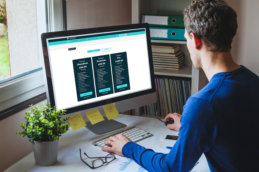 Man looking at the different Erudus subscription pricing tables