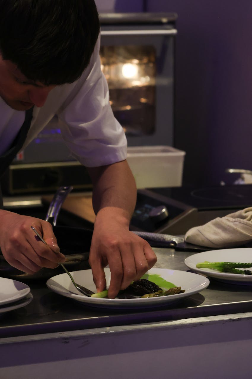 A chef at the Expo assembling an immaculate dish of food.