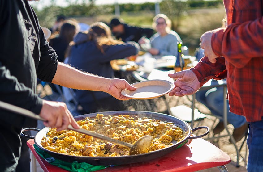 What is traditionally in paella?  Paella being served