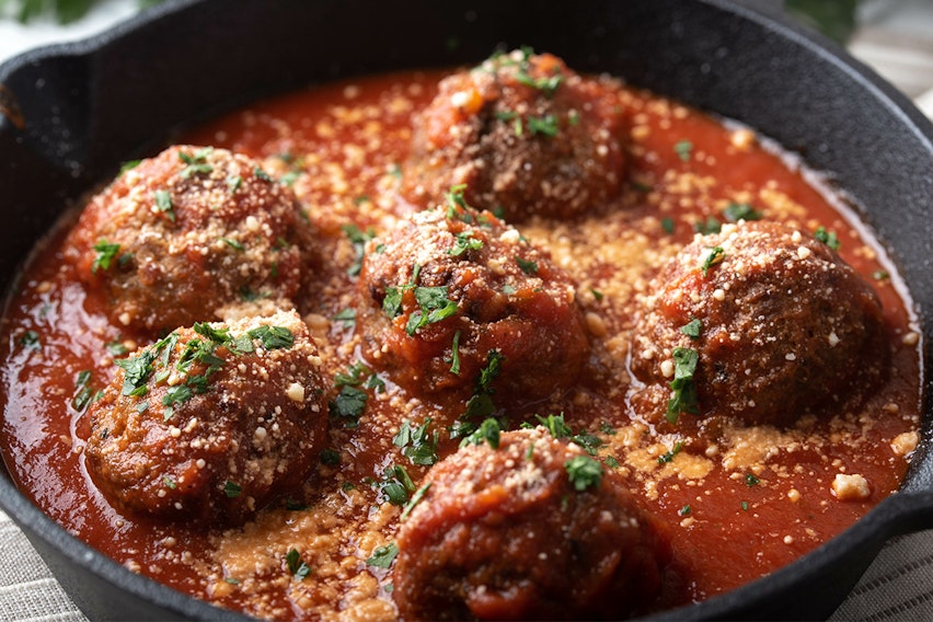 What to add to meatballs to make them taste better - meatballs simmering in sauce