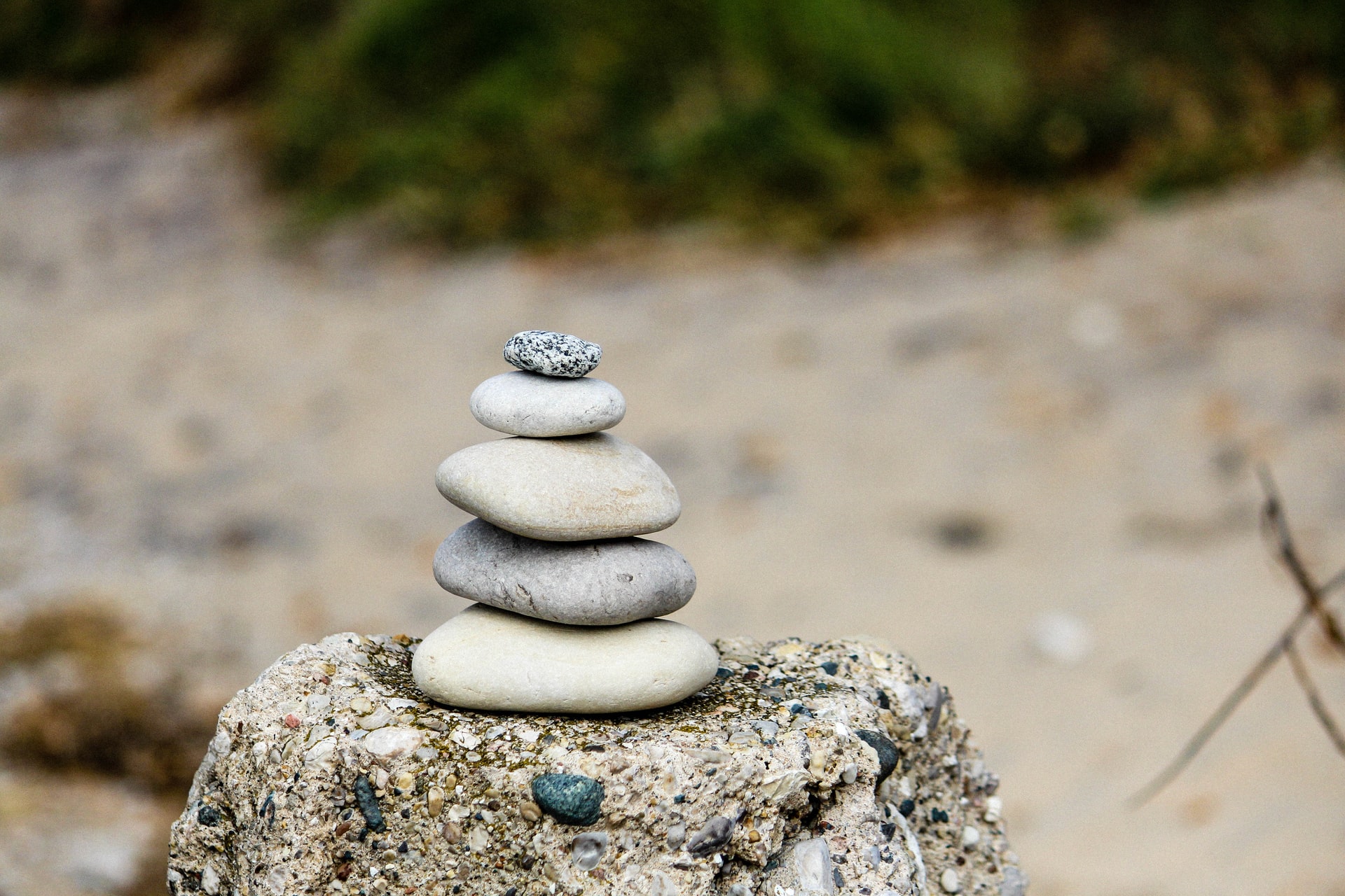 Rocks stacked on a post at the beach