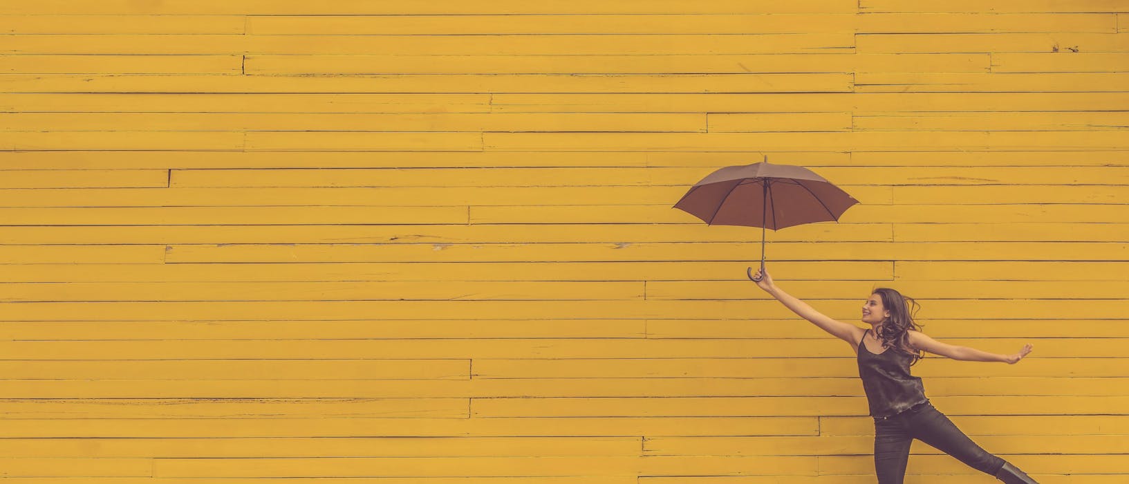 woman holding brown umbrella