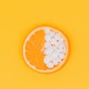 orange fruit slices on yellow surface