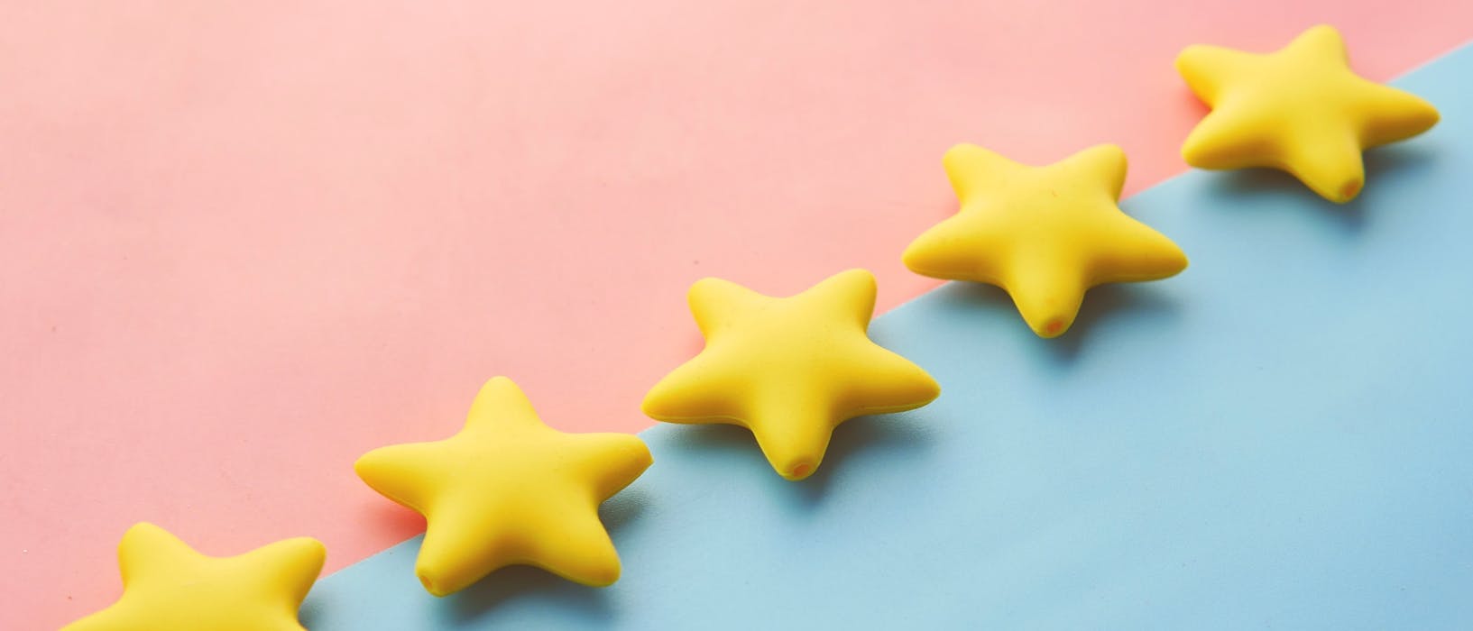 Five yellow stars on a pink and blue background